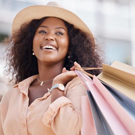 Woman smiling while carrying shopping bags