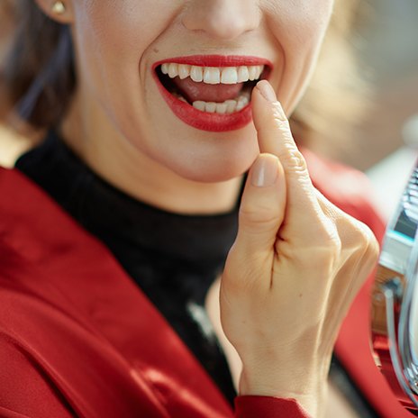 A woman pointing to her tooth