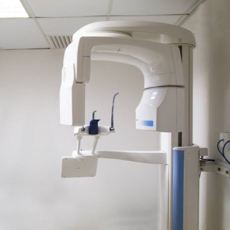 C T cone beam scanner against white wall of dental office