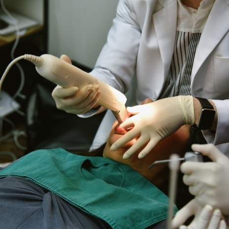 Dentist taking digital impressions of a patients teeth