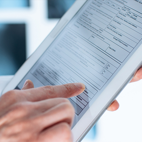 Person filling out dental patient forms on tablet