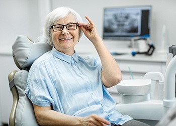 Mature female patient with glasses at dentist’s office