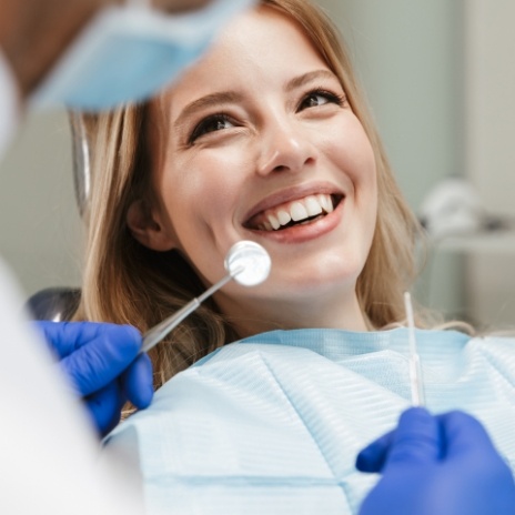 Woman smiling at her dentist during preventive dentistry checkup