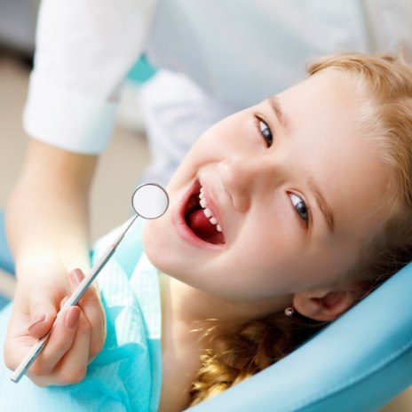 Young girl smiling in dental chair