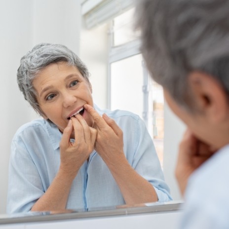 Woman flossing her teeth