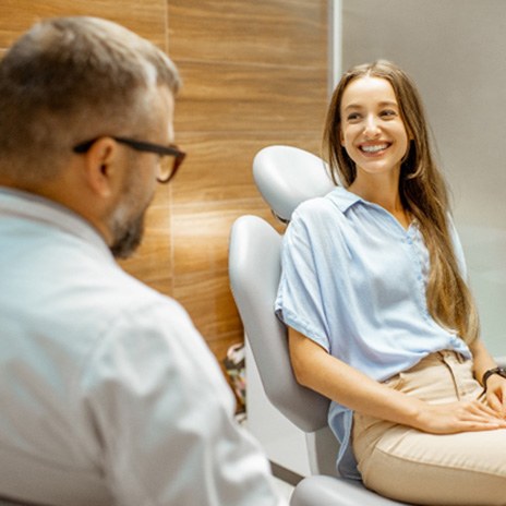 Female patient smiling at dentist at dental appointment