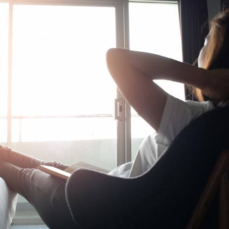 Woman relaxing in her favorite chair with coffee nearby