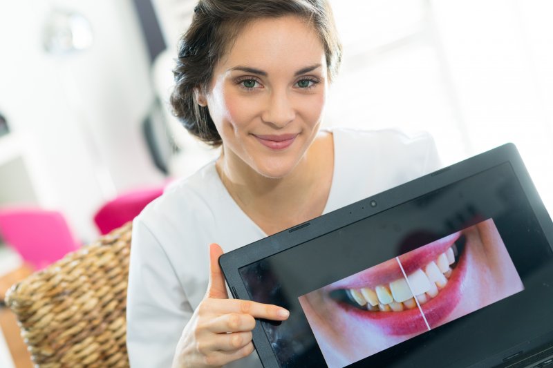 dentist showing a beautiful smile on a tablet
